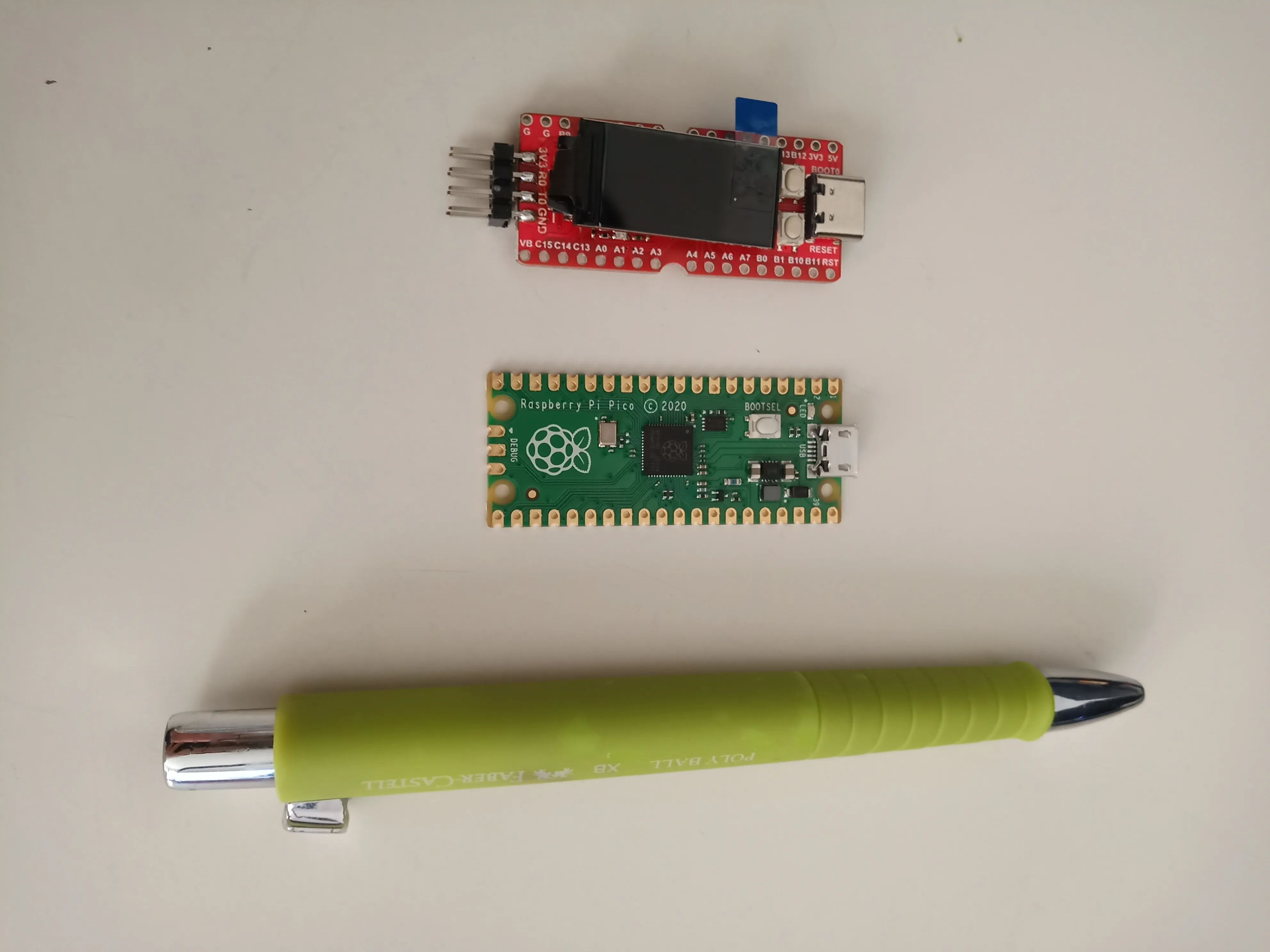 The Longan Nano, Raspberry Pi Pico and a pen for scale.